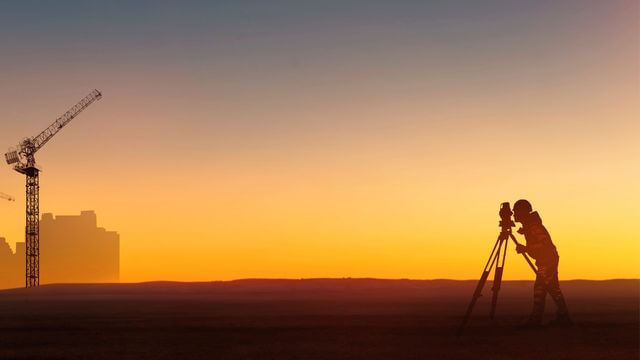 A land surveyor surveying a project in Modesto, CA