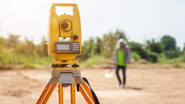 A surveyor working on a construction project.